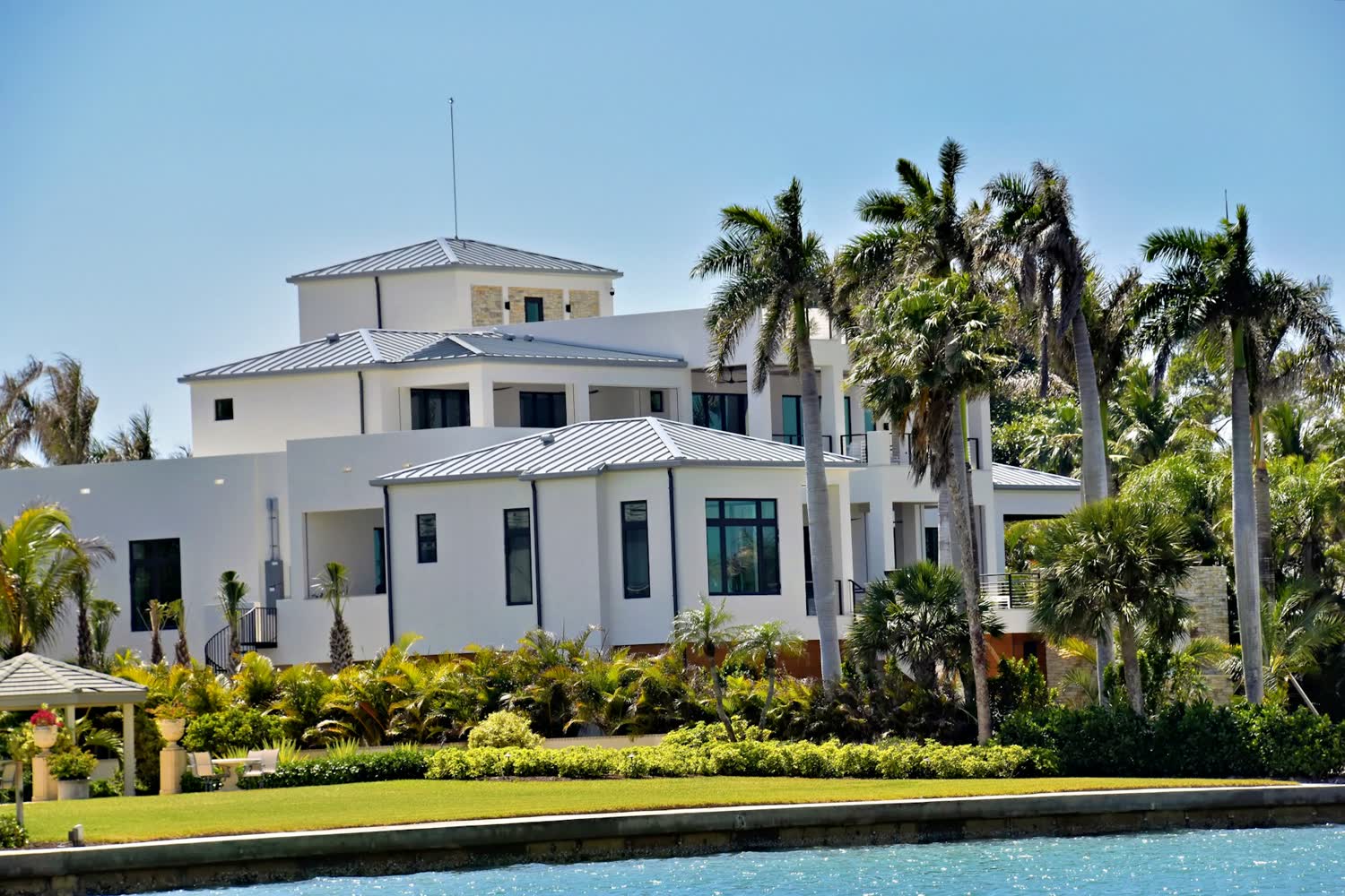 Single-family South Florida rental home with palms and a front walkway